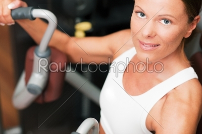 Woman in gym on machine exercising