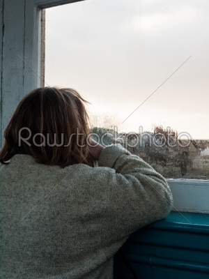Woman Looking Out of a Window
