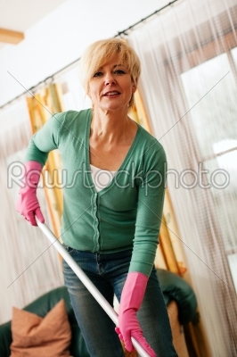 Woman mopping the floor in her home