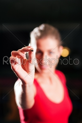 Woman playing darts