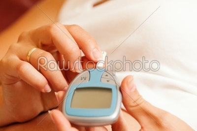 Woman testing glucose for diabetes