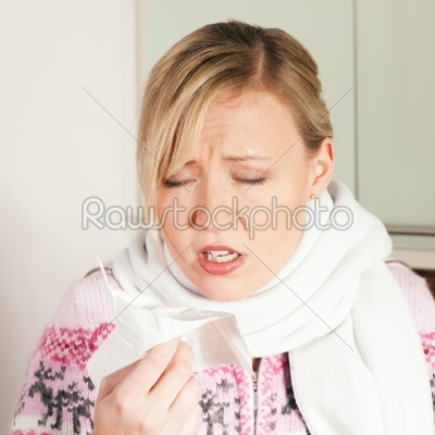 Woman with cold or flu sneezing