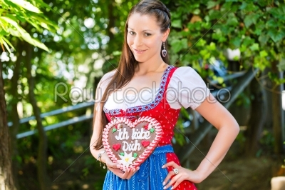 Woman with gingerbread hart in Bavaria beergarden