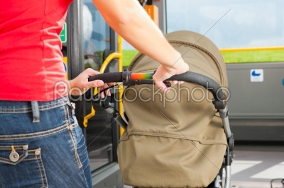 Woman with stroller getting into a bus