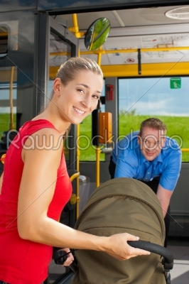 Woman with stroller getting into a bus