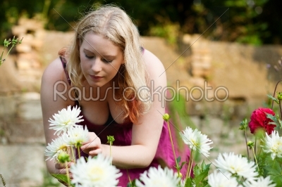 Woman working in the garden with flowers