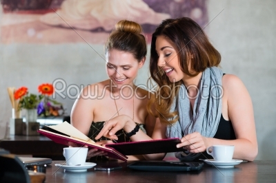 Women in restaurant choosing foor in menu