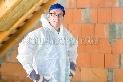 Worker attaching thermal insulation to roof