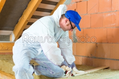 Worker cutting insulating material