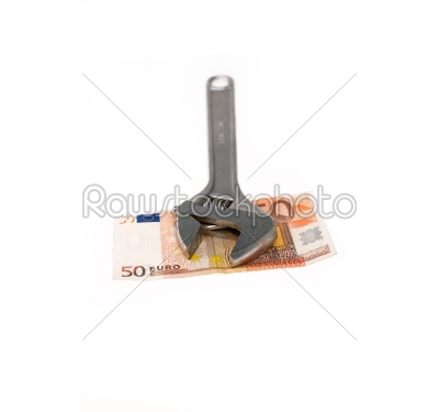 wrench and euro isolated on white