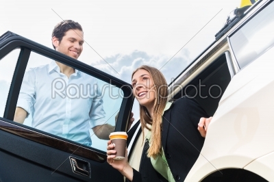 Young businesswoman getting out of taxi