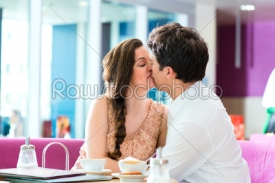 Young couple cafe hugging and kissing