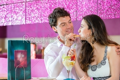Young couple enjoying their time in ice cream parlor