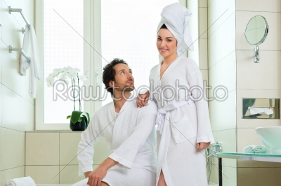 Young couple in bathrobe in hotel bathroom