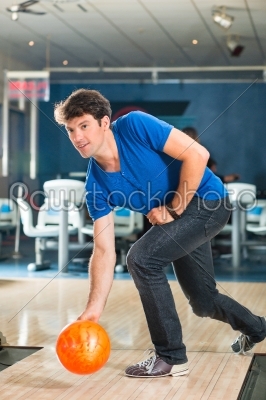 Young man bowling having fun