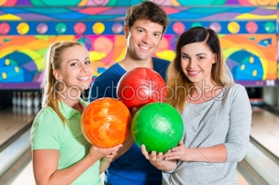 Young people playing bowling and having fun