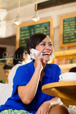 Young woman in an Asian coffeeshop