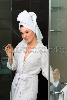Young woman in bathrobe in hotel bathroom