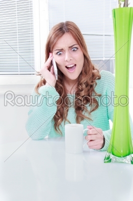 young woman on cellular phone with negative reaction