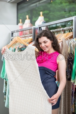 Young woman shopping in fashion department store