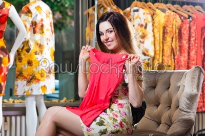 Young woman shopping in fashion department store