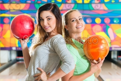 Young women playing bowling and having fun