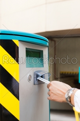 stock photo: hand is inserting parking ticket into barrier of garage-Raw Stock Photo ID: 42571