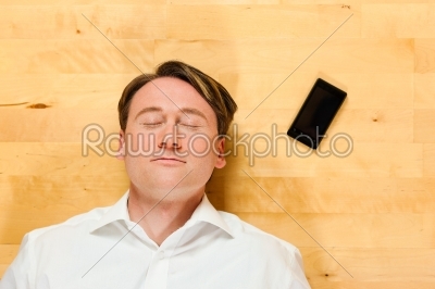 stock photo: man lying on the floor beside mobile phone-Raw Stock Photo ID: 41284