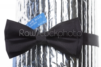 a black bow-tie with label air mail