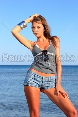 a young and sexy woman in jeans shorts 