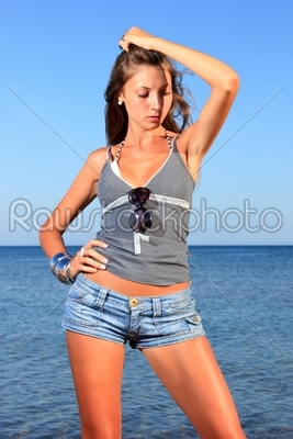 a young and sexy woman in jeans shorts 