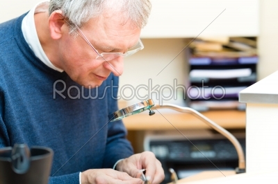 Acoustician working on a hearing aid