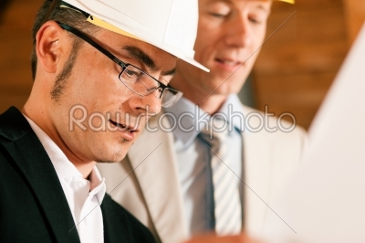Architect and construction engineer discussing plan