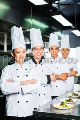 Asian Chef in restaurant kitchen cooking