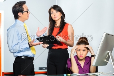 Asian colleagues mobbing or bullying employee 