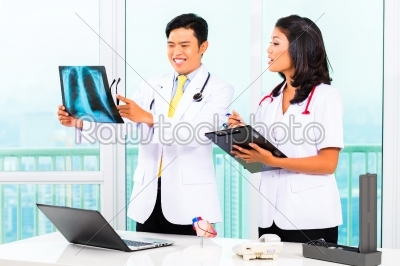 Asian doctor and nurse in surgery