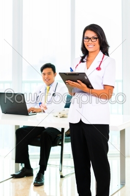 Asian doctor and nurse in surgery or office