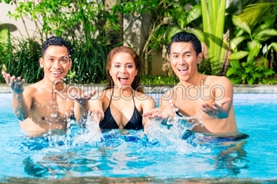 Asian friends swimming in pool