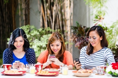 Asian girls using their mobile phones