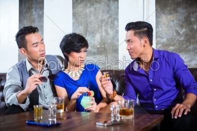 Asian man harassing woman in fancy nightclub