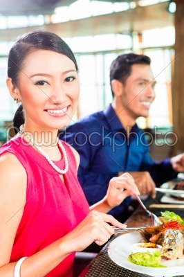 Asian people fine dining in restaurant