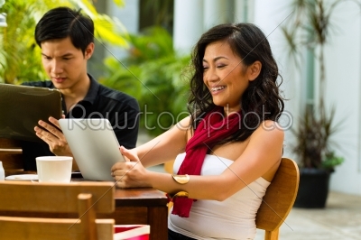 Asian people in cafe with computer