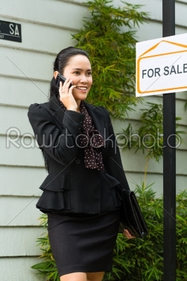 Asian Realtor presenting a new home