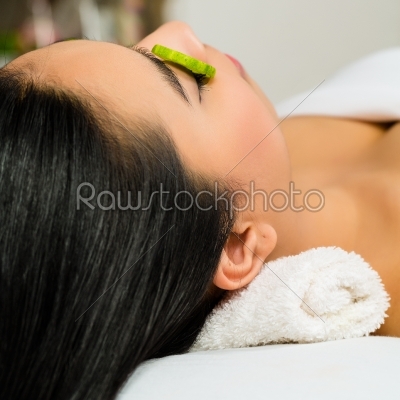 Asian woman getting a facial treatment in spa