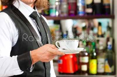 Barista making cappuccino in his coffeeshop