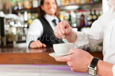 Barista with client in his cafe or coffeeshop