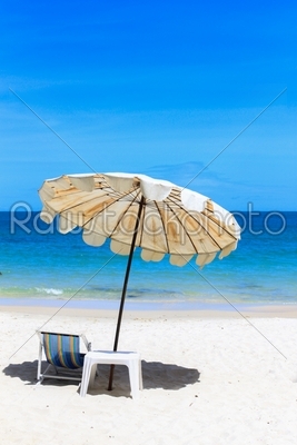 Beach chair and umbrella on idyllic tropical sand beach.