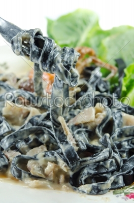 black pasta on fork
