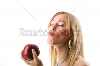 Blonde woman eating a red apple