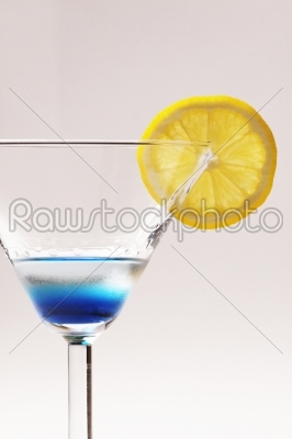 blue cocktail with yellow lemon